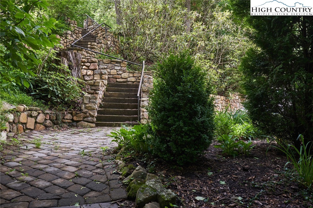 Downhill side of the house, brick lower level and deck.